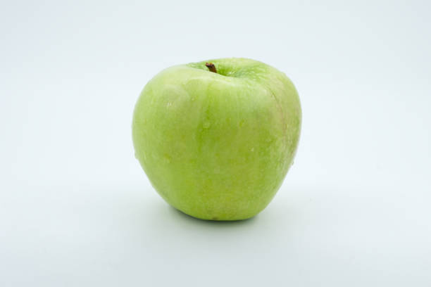 a green apple on a table