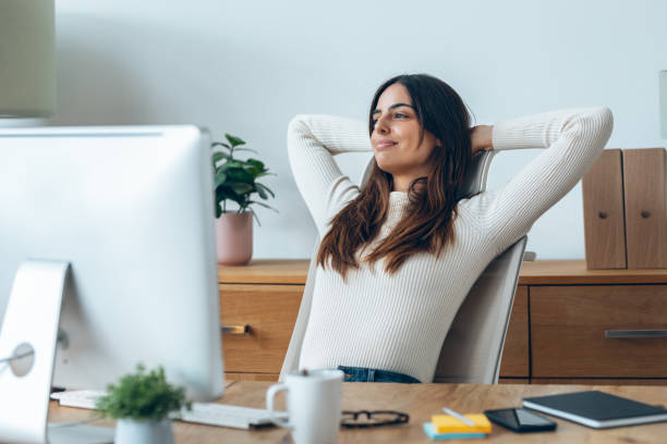 istock Tired businesswoman stretching body for relaxing while working with computer in the office. 1923061423