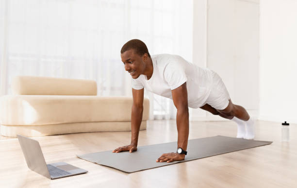 istock Motivated african american man exercising at home 1923069554
