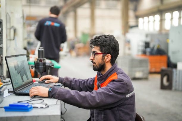 istock technician who makes cad-cam programs for cnc machines in industry 1923069967