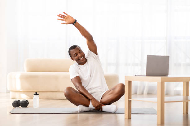 istock Cheerful Smiling Black Guy Training In Living Room 1923069969