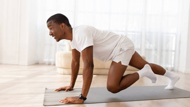 istock Active african american young man doing cardio exercises at home 1923069980