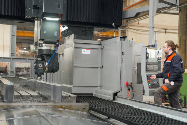 istock Young technician working on big cnc machine in industry. production in industry 1923072661