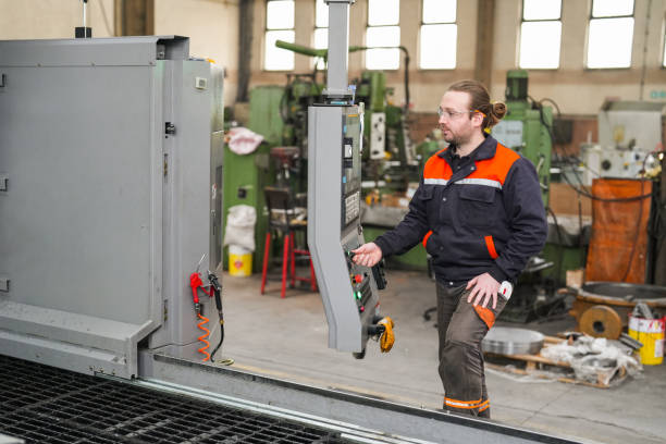 istock Young technician working on a CNC machine in the industry. production in industry 1923080055