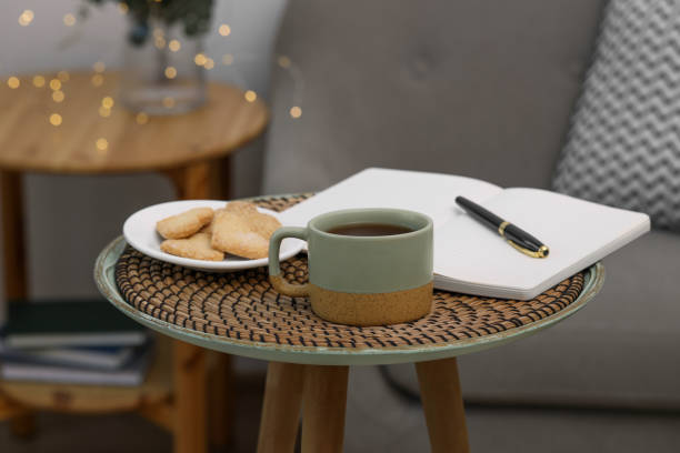 istock Cup of drink, cookies and notebook on coffee table indoors 1923087831