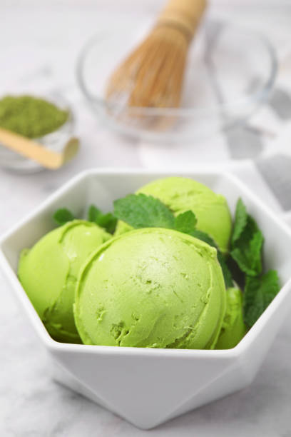 istock Tasty matcha ice cream in bowl on white table, closeup 1923090012