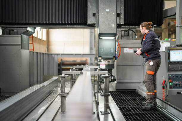 istock Young male technician working on big machine in industry 1923106142