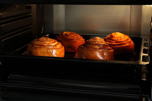 istock Baking delicious spiral buns in electric oven 1923118589
