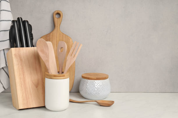 istock Set of different kitchen utensils on white near gray wall. Space for text 1923119632