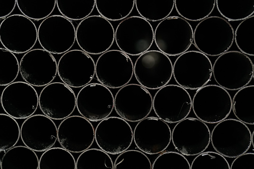 Round iron pipes lined up in industry