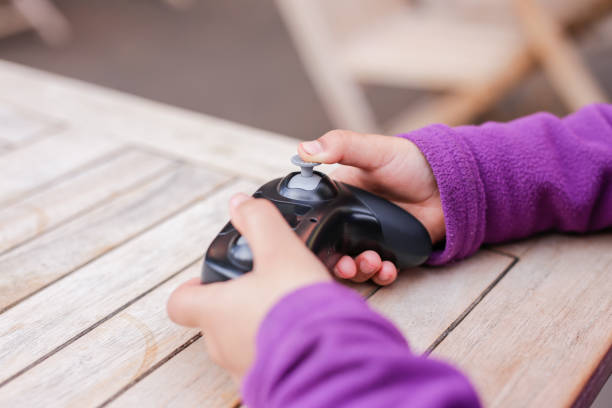 istock Little Girl's Hands Holding Drone Control 1923154304