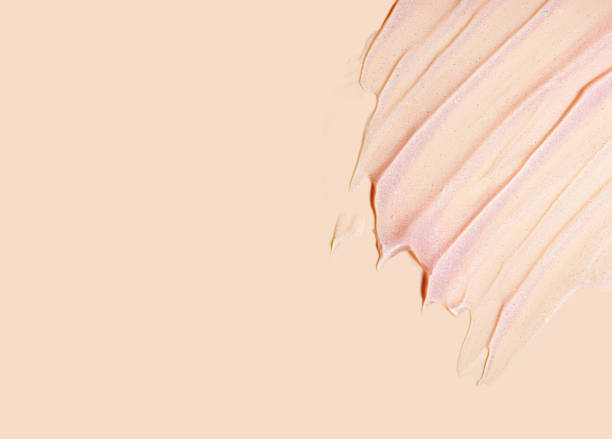 istock Cosmetic shimmer glitter texture. Gel smudge swatch on peach background. 1923188823