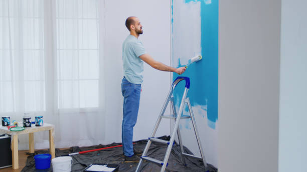 istock Handyman painting wall 1923199639