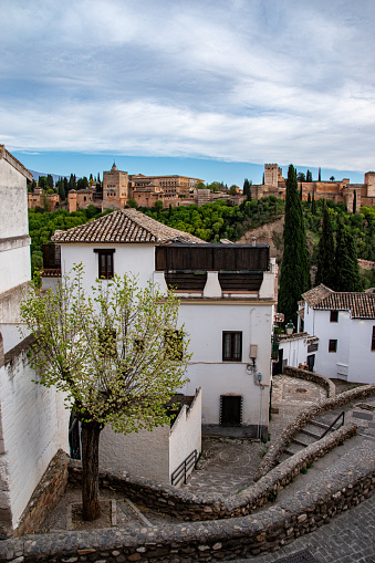 View of the Alhambra between houses in the Albaicín neighborhood. Granada.