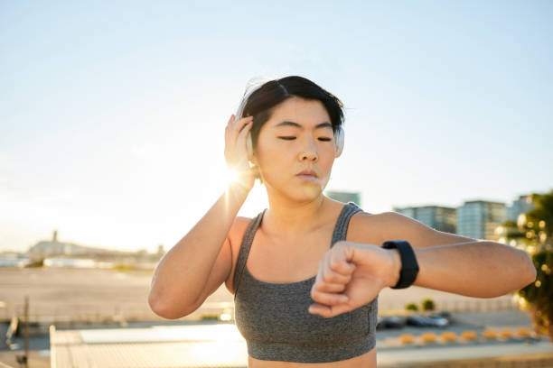 istock Asian girl touching her smartwatch while doing sports 1923212069