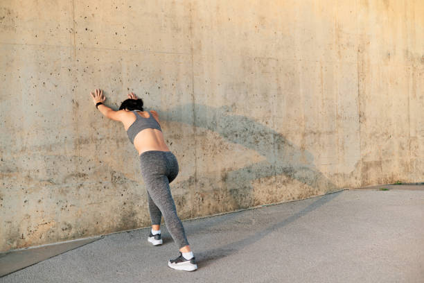 istock Woman stretching her body before workout 1923220507