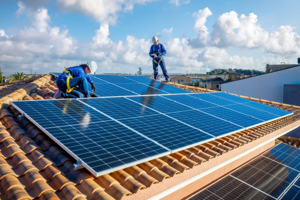 istock Male and female workers installing solar panels in a roof 1923229425