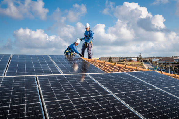 istock Male and female workers installing solar panels in a roof 1923229429