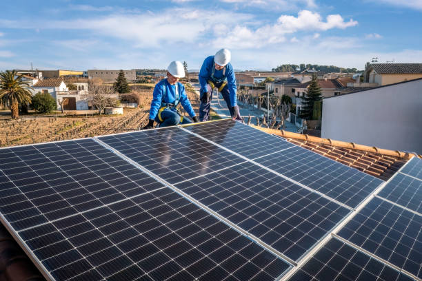 istock Male and female workers installing solar panels in a roof 1923229431