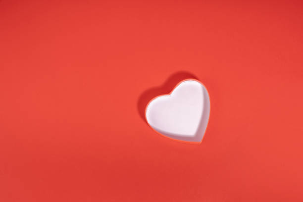 istock Simple white and red heart 3d flat lay on red background 1923253064