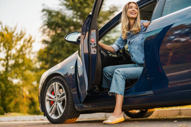 istock Young woman driving a car and smiling 1923254098
