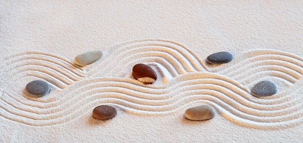 Zen garden with the stones and white sand