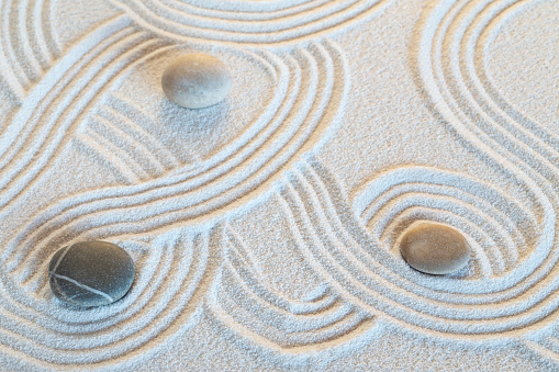 Zen garden with the stones and white sand