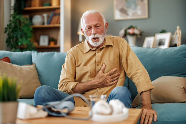 istock Senior man sitting on sofa at home with sickness 1923260930
