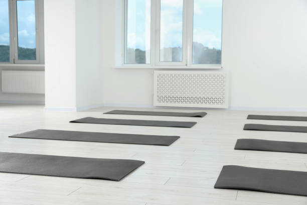 istock Spacious yoga studio with exercise mats on floor 1923262503