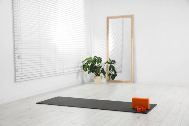 istock Exercise mat, yoga block and dumbbells at home. Space for text 1923262507
