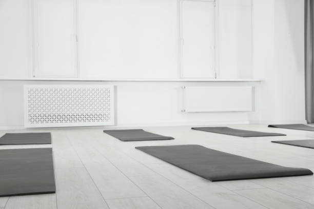 istock Spacious yoga studio with exercise mats on floor 1923266674