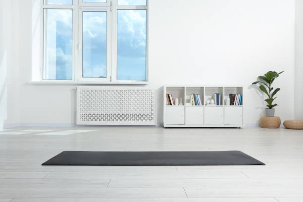 istock Grey yoga mat on floor in room 1923266684