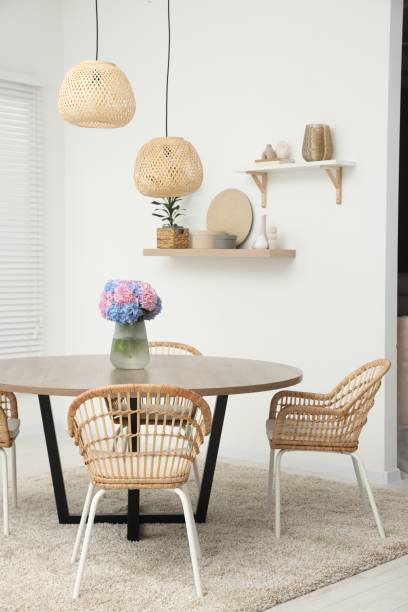 istock Table, chairs and vase of hydrangea flowers in dining room. Stylish interior 1923299824