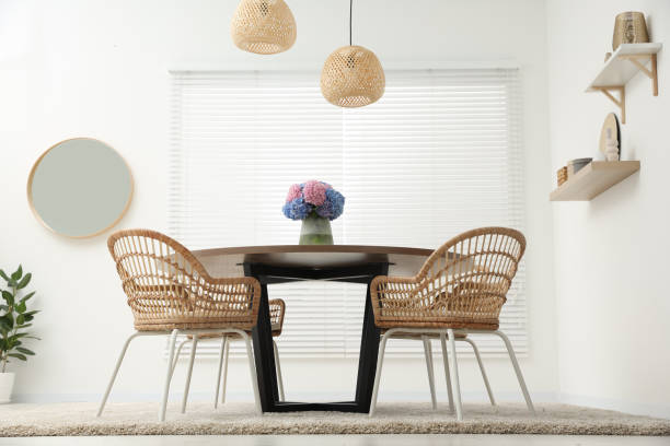 istock Table, chairs and vase of hydrangea flowers in dining room, low angle view. Stylish interior 1923316379