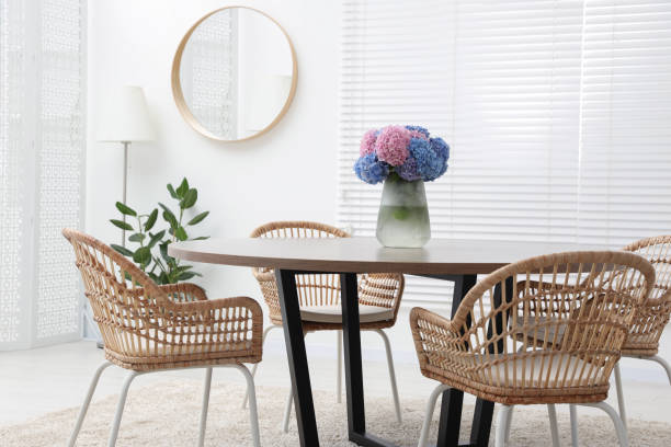 istock Table, chairs and vase of hydrangea flowers in dining room. Stylish interior 1923316549