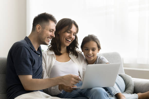 istock Cheerful mother, father and daughter kid resting on comfortable couch 1923317593