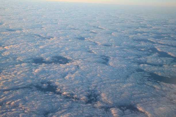 istock earth and clouds from airplane 1923324299