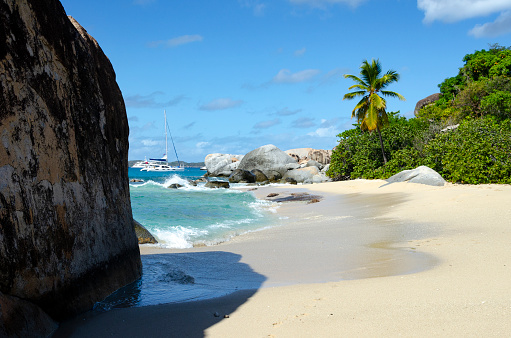 An image of the striking area known as Devils Bay & The Baths in the British Virgin Islands, renowned for its unique geological formations of giant boulders and crystal-clear tidal pools. This natural wonder, set against a backdrop of lush greenery and azure waters, creates a surreal and picturesque landscape, emblematic of the islands' breathtaking beauty.