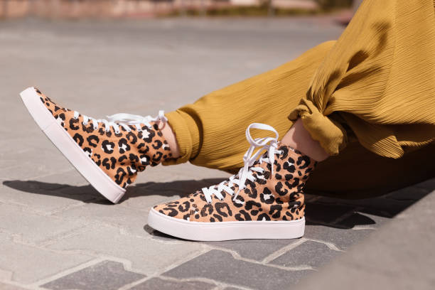 istock Woman wearing sneakers with leopard print outdoors, closeup 1923333697