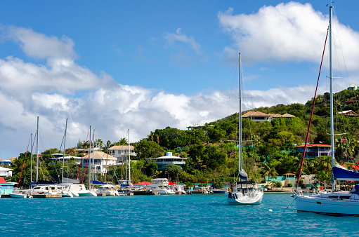 Sailing in the British Virgin Islands, capturing the essence of a perfect day on the water with clear blue skies and the tranquil Caribbean Sea. The sails billowing in the breeze against the backdrop of idyllic islands epitomise the ultimate sailing adventure in this tropical paradise.