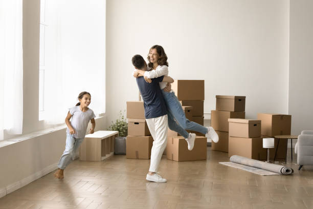 istock Strong young dad hugging and lifting cheerful mom in arms 1923337951