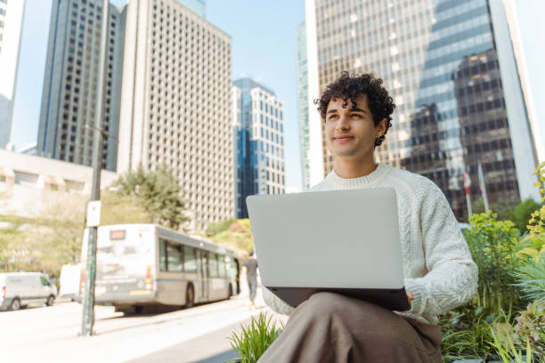 istock Young confident hispanic businessman using laptop working online outdoors 1923379283
