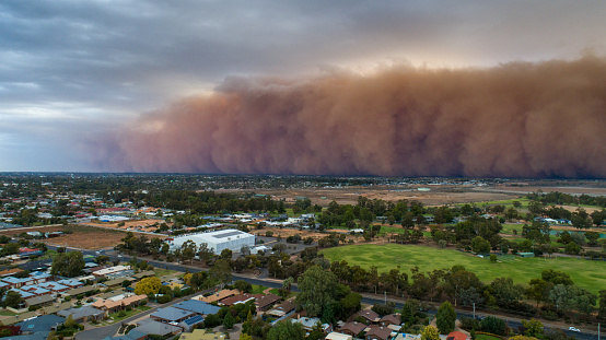 Aerial view of a massive dust storm approaching a city (Mildura) regional Australia