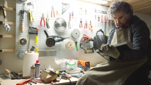 istock Carpenter working late in his workshop. Small business owner. 1923401724