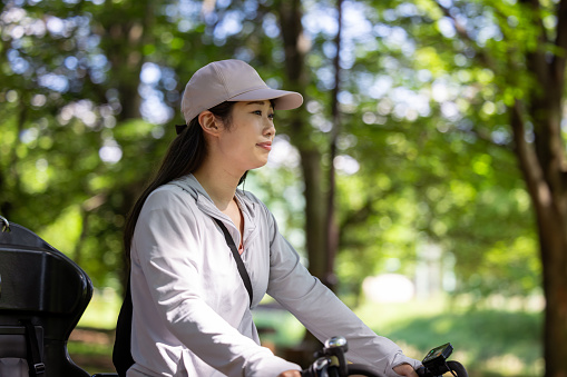 Woman riding bicycle in public park