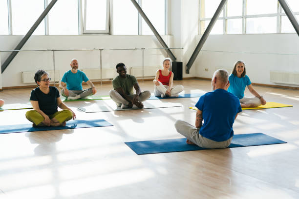 istock Group of senior athletes raise hands to ceiling at workout 1923491474