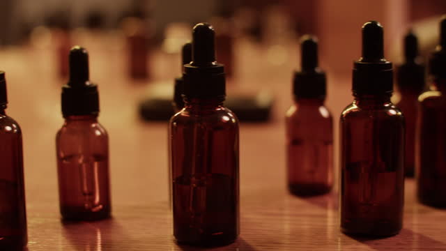 Bottles of essential oils in dark workshop