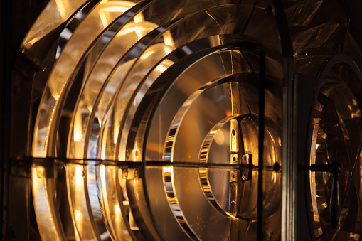 Lighthouse lamp with Fresnel lens mounted on metal frame, close up photo