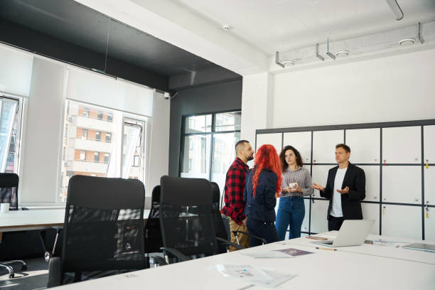 istock Team of managers drinking coffee and talking to in informal atmosphere 1923544513