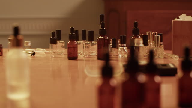 Different bottles placed on table in perfume lab
